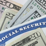 Social Security Card with cash money dollar bills - living on a fixed income, benefits SSN