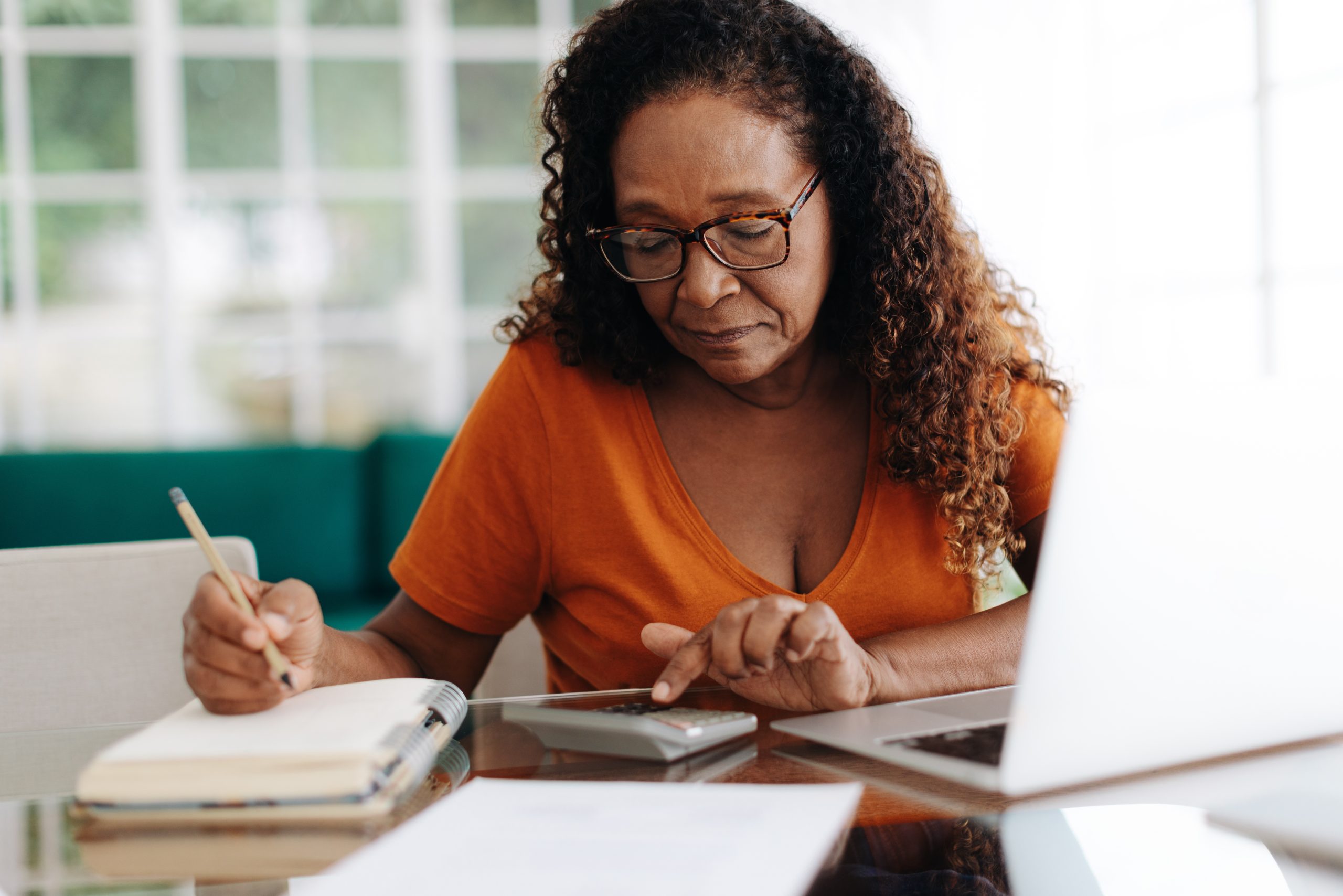 What is Deeming of Income in Social Security Disability Insurance? Senior woman making calculations on her retirement annuity, reviewing her pension plan and social security benefits. Elderly black woman using her financial literacy and planning skills at home.