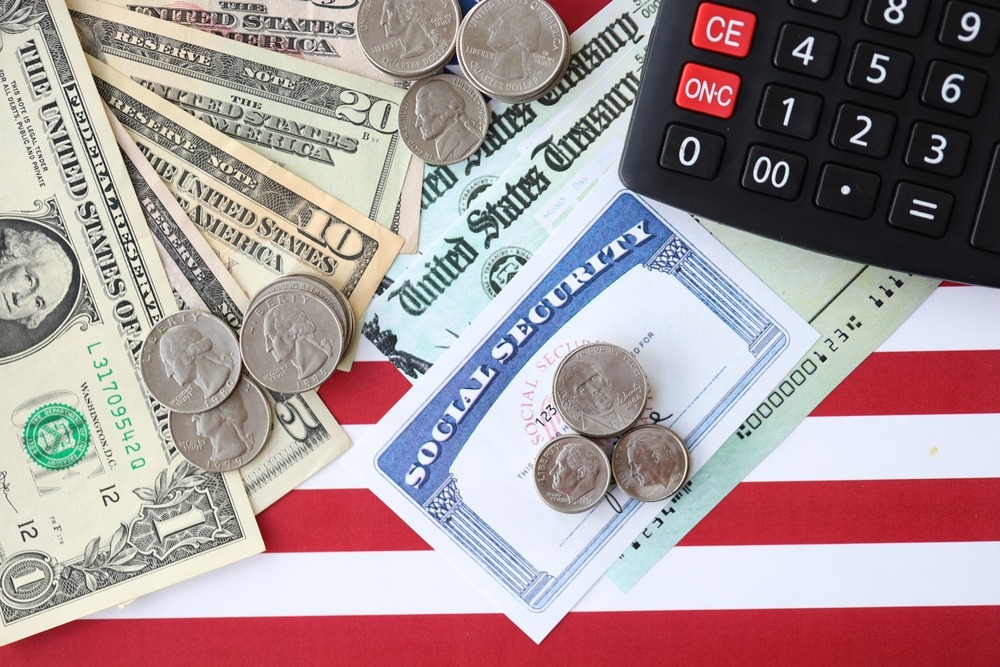 Social Security card with U.S. currency and calculator