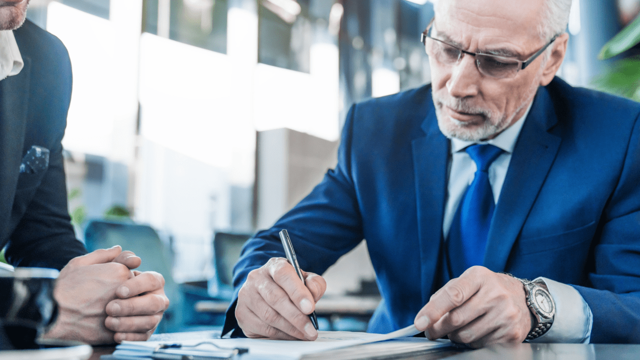 Two men review VA disability and SSDI work assessment documents