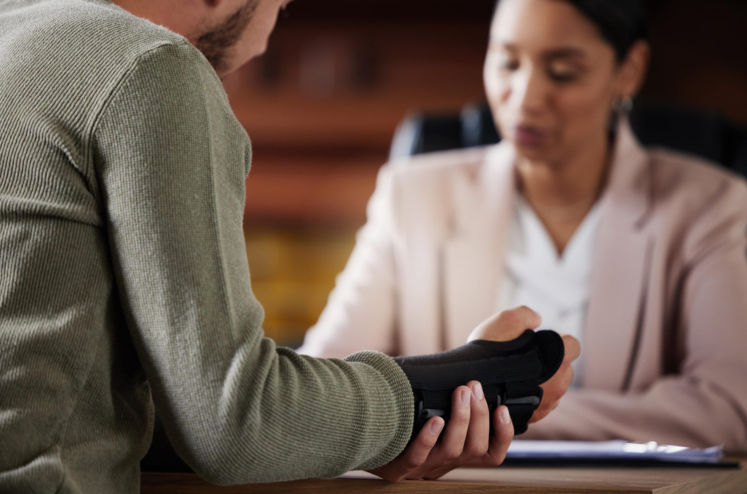 A concerned individual discusses a difficult disability claim with a lawyer, highlighting the challenge of proving conditions like chronic pain or mental illness.