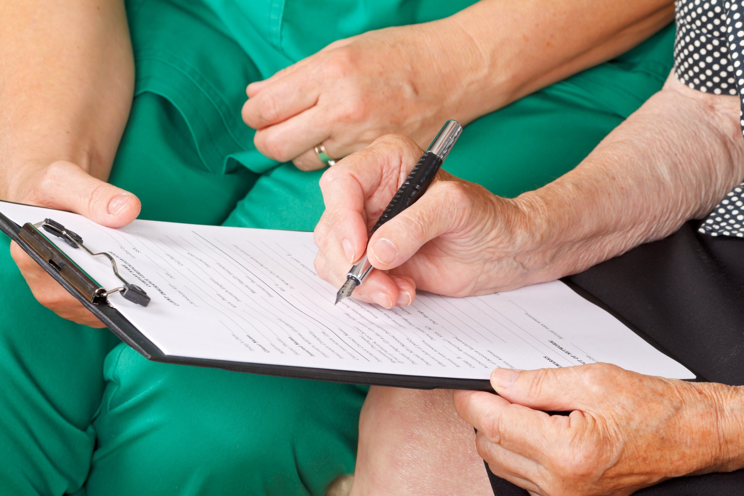 Disability lawyer and client reviewing medical documents related to SSDI claim for a commonly approved condition such as a spinal injury or severe mental disorder.