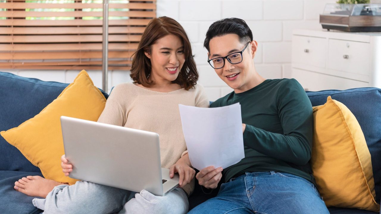 Man smiles while viewing SSDI back pay bank statement at home