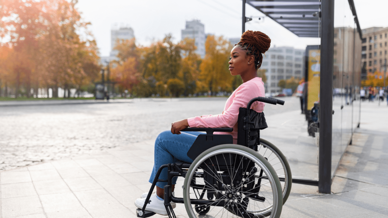 Young woman in wheelchair outdoors — what gets you approved for SSDI?