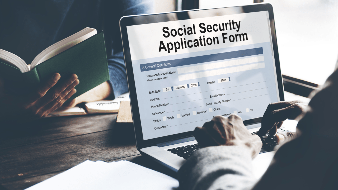 What not to say when applying for SSDI Person filling out a Social Security Application Form on a laptop computer, with hands visible typing on the keyboard