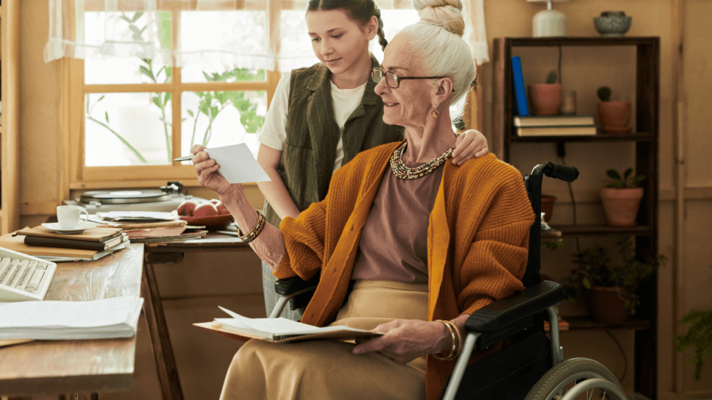 Senior woman in wheelchair reviewing Social Security documents with caregiver to learn how to get $3000 a month from Social Security