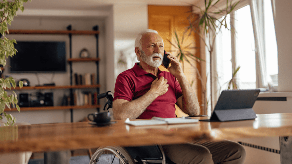 Senior man on phone researching at what age do you not get out of your full Social Security benefits at home office