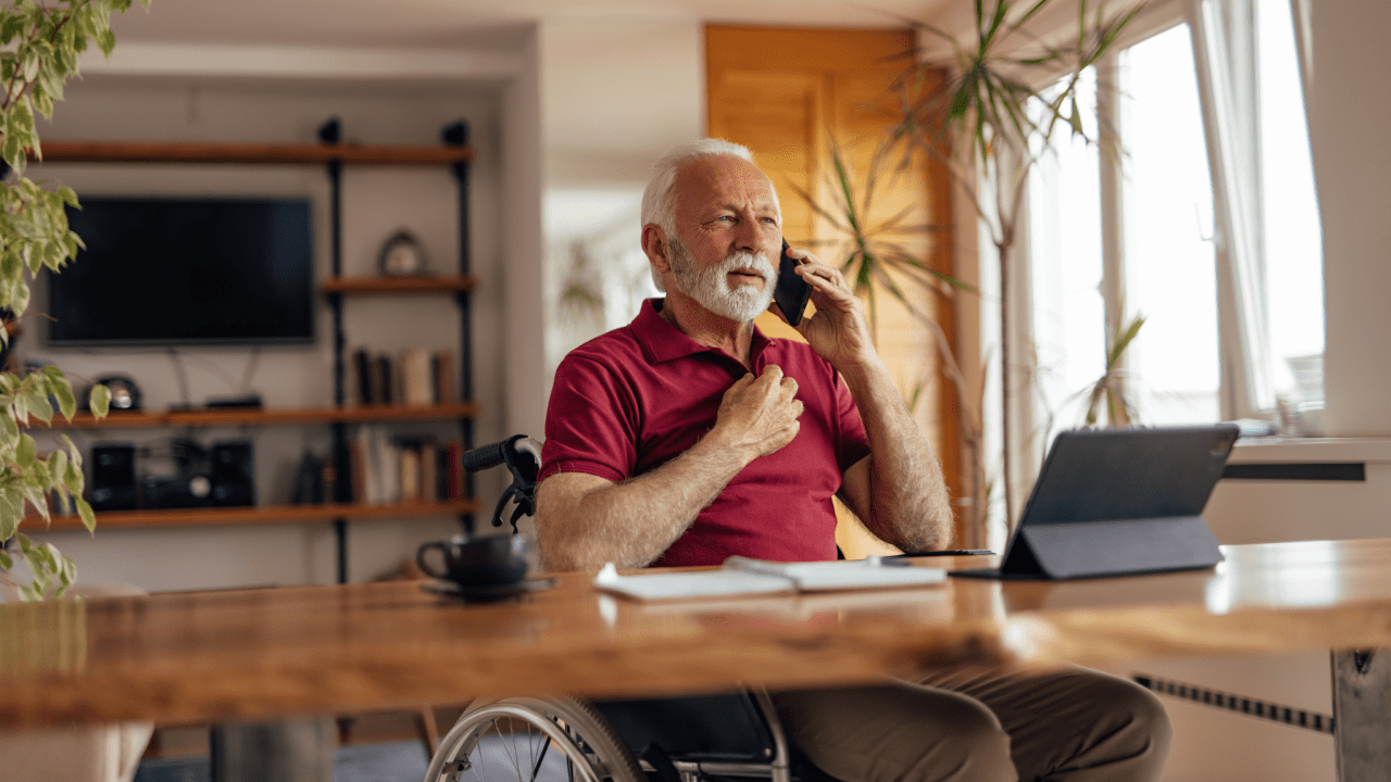 Senior man on phone researching at what age do you not get out of your full Social Security benefits at home office