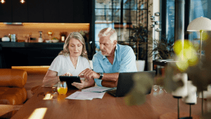 Middle-aged couple reviewing Social Security disability paperwork and wondering can you work full time and collect Social Security disability benefits