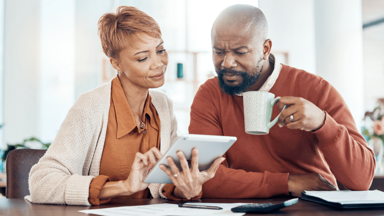 Couple reviewing how much can you make working while on disability income limits on a tablet