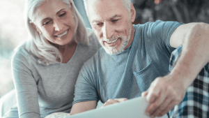 Happy older couple reviewing SSDI eligibility documents together at home