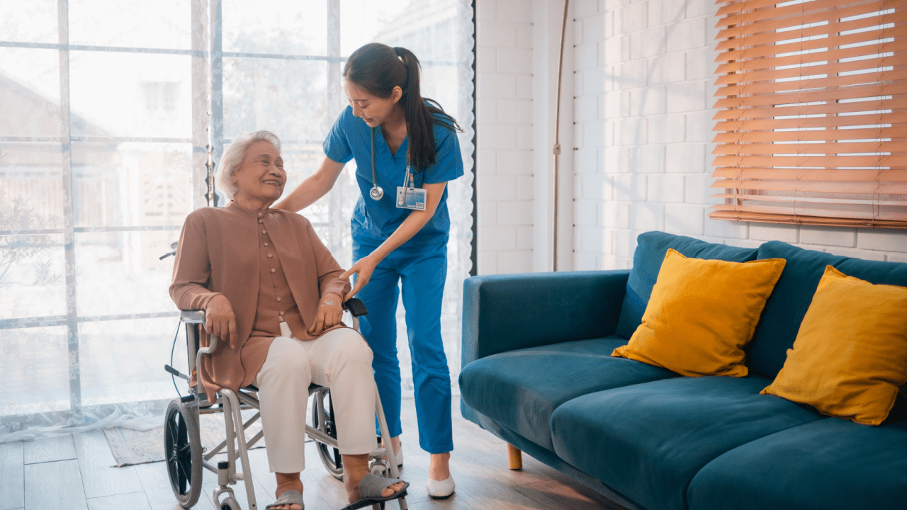 Healthcare worker assisting senior woman in wheelchair discussing who qualifies for extra $144 added to their Social Security