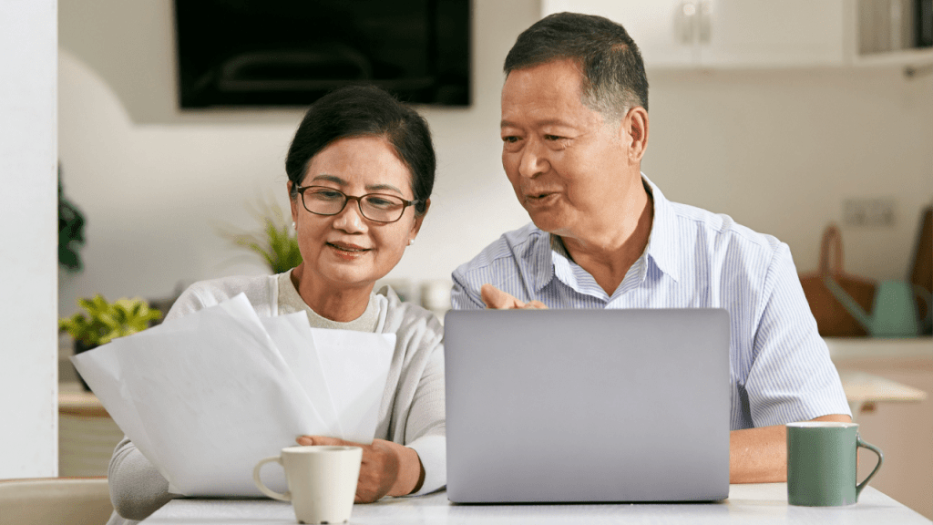 Asian senior couple reviewing documents to learn can you get SSI and SSDI at the same time