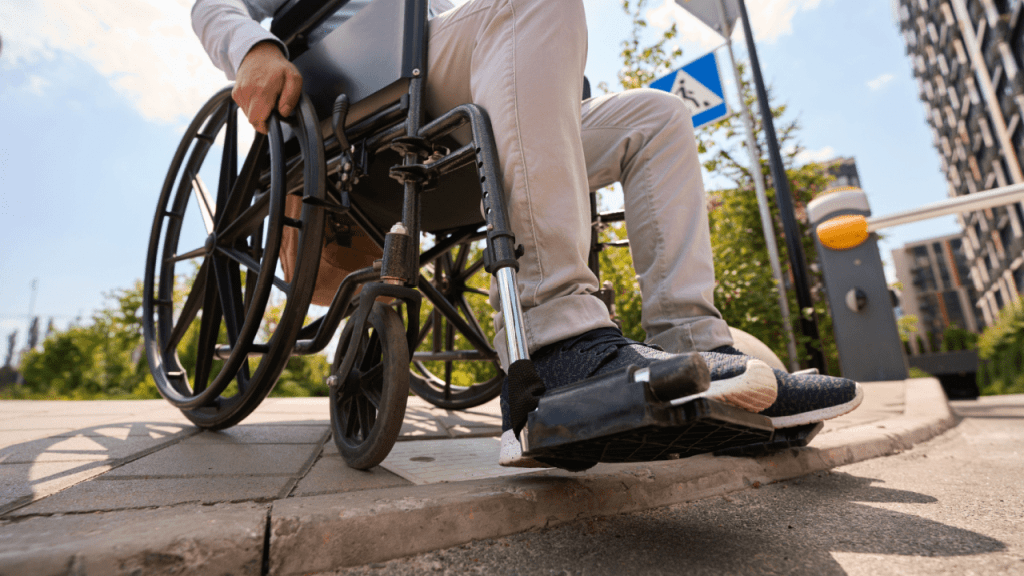 Person in wheelchair on city sidewalk considering benefits - does SSDI pay more than regular Social Security