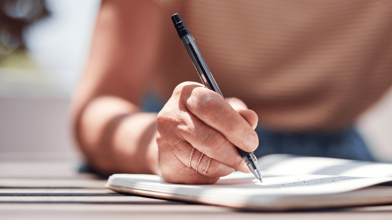Close-up of hand writing calculations to understand how does SSDI determine how much you get
