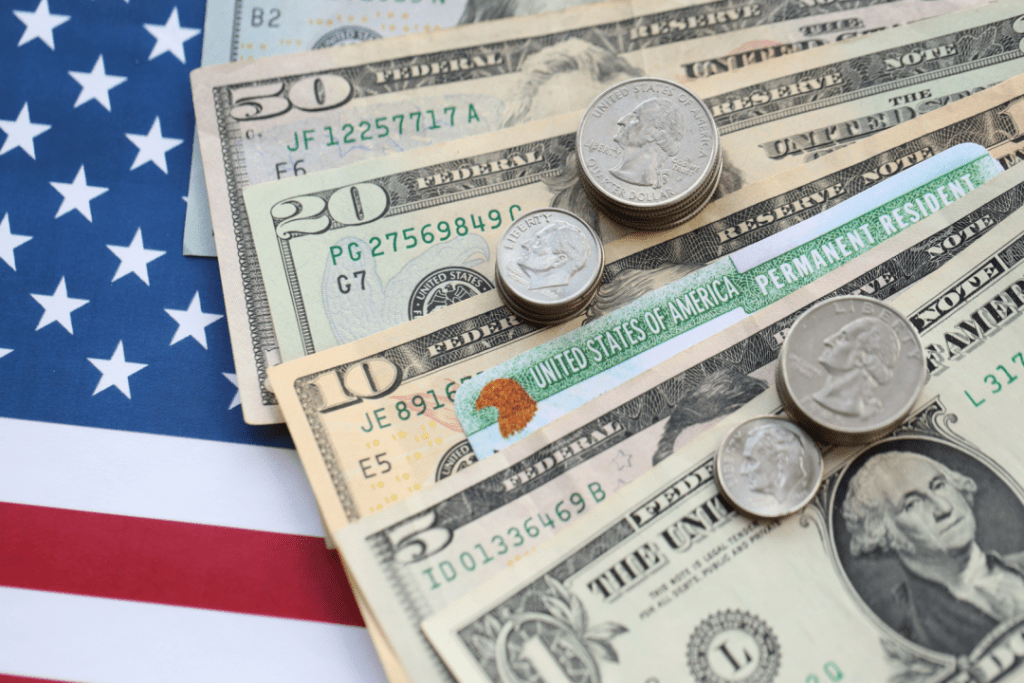 US dollars and coins on an American flag representing Social Security COLA 2026 benefits increase