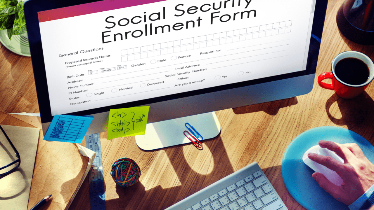 Person completing Social Security Disability rules and requirements application form on computer screen with workspace setup