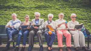 Senior adults using tablets and phones representing what are the four types of disability accessibility needs
