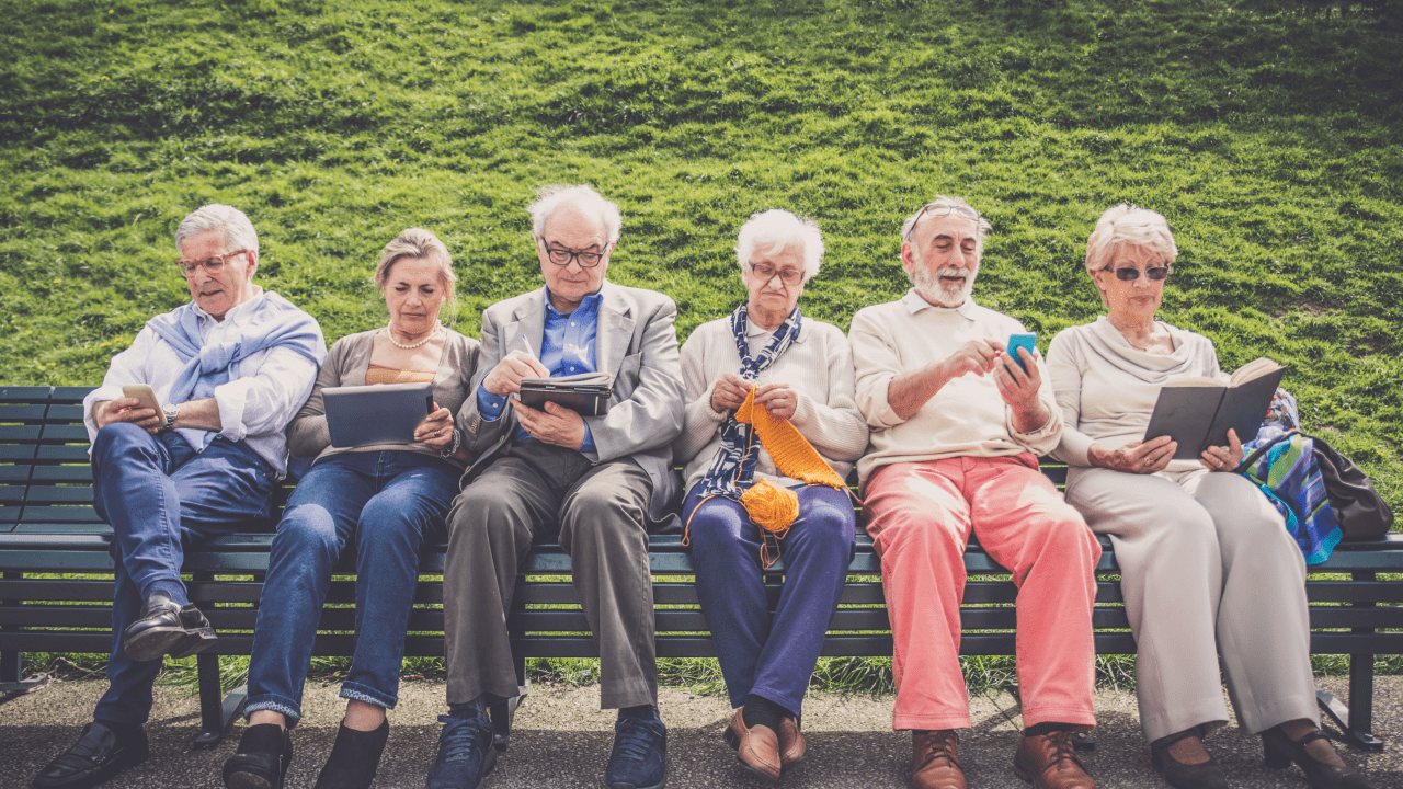 Senior adults using tablets and phones representing what are the four types of disability accessibility needs