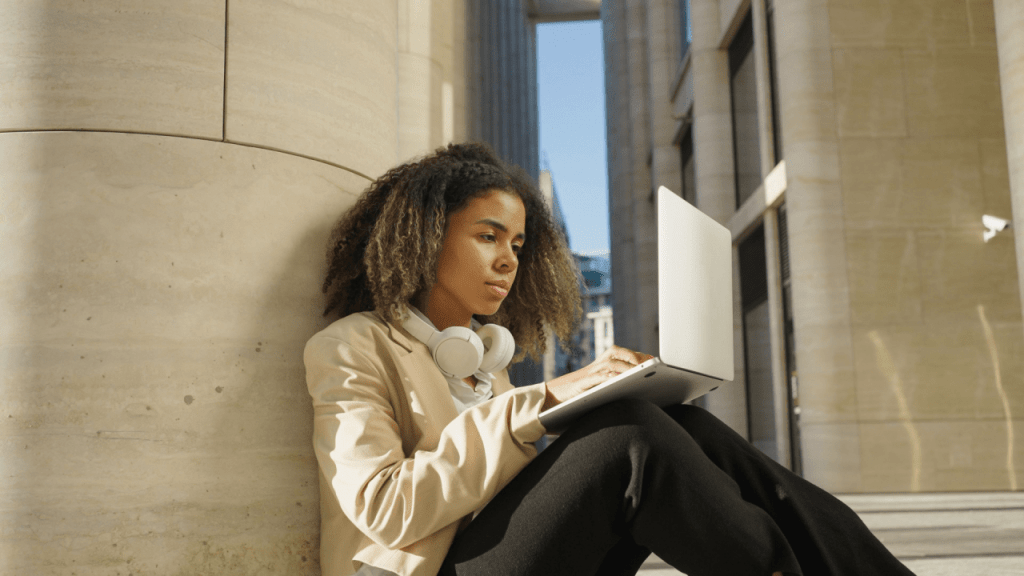 Woman with laptop researching SSDI asset limit requirements while sitting in modern building