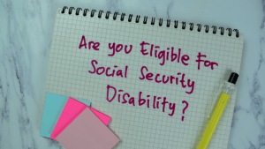 Handwritten notebook page asking "Are you eligible for Social Security Disability?" with colorful sticky notes and pen, related to who is not eligible for SSDI