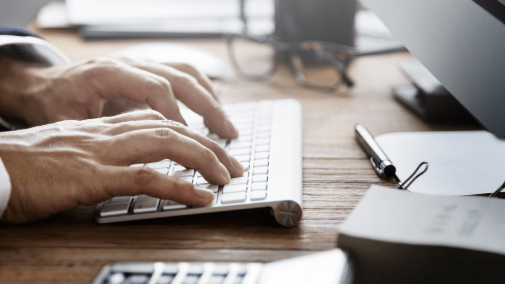 Person typing research about what are the odds of winning a social security disability hearing