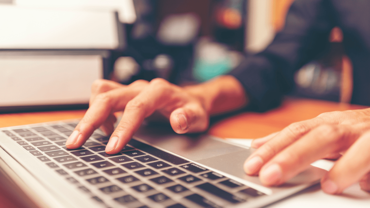Person typing on laptop researching what makes a strong disability case