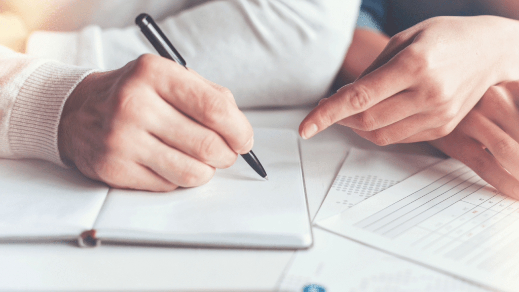 Person completing disability application forms with pen, researching what are the chances of getting approved for disability with a lawyer and legal representation benefits