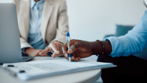 Professional implementing strategies to win SSDI reconsideration during client document signing session