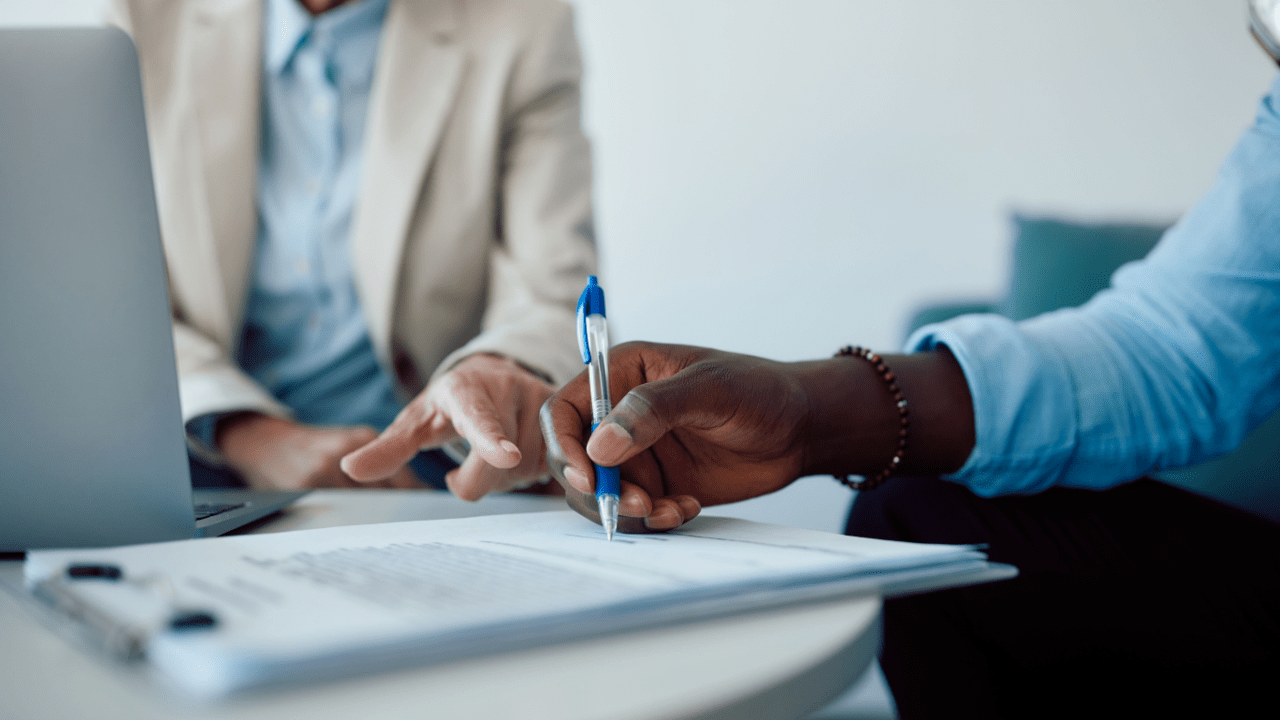 Professional implementing strategies to win SSDI reconsideration during client document signing session