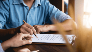 Person completing SSDI reconsideration paperwork to learn what are the steps of SSDI reconsideration process