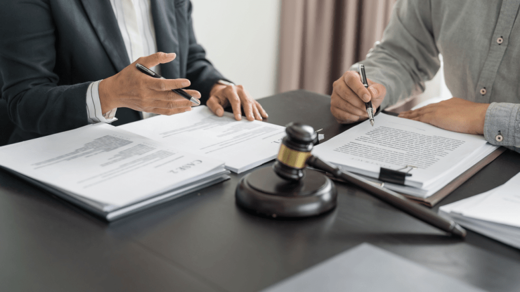 Legal professionals reviewing documents about what happens to SSI or SSDI payments during reconsideration with gavel on table