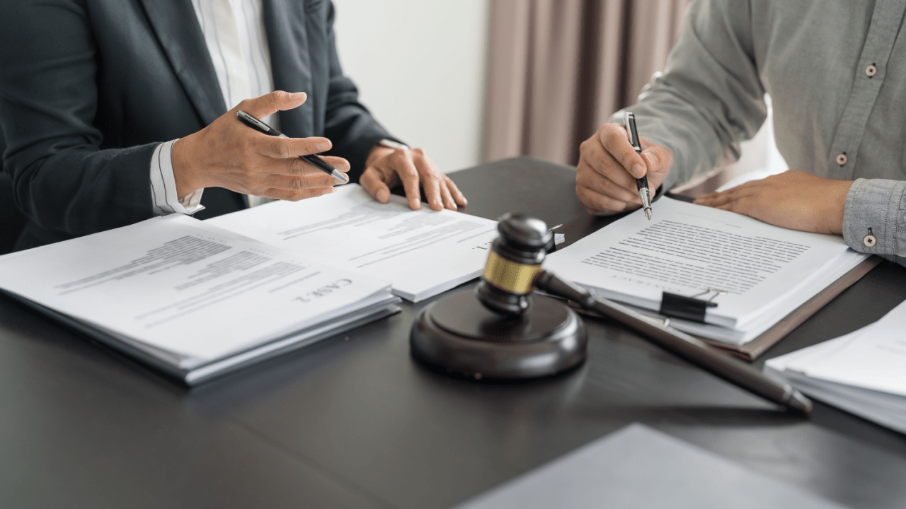 Legal professionals reviewing documents about what happens to SSI or SSDI payments during reconsideration with gavel on table