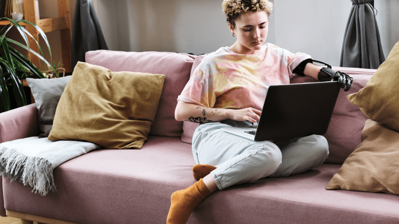 Person with prosthetic hand researching what is the maximum back pay for disability on laptop