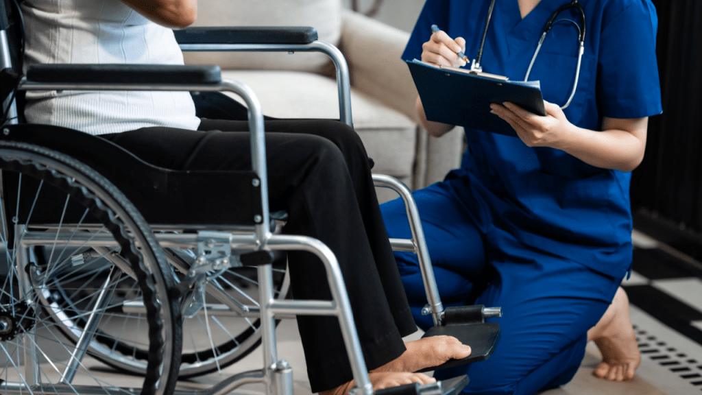 Healthcare professional conducting disability assessment with clipboard and wheelchair visible, demonstrating how to pass a disability assessment process