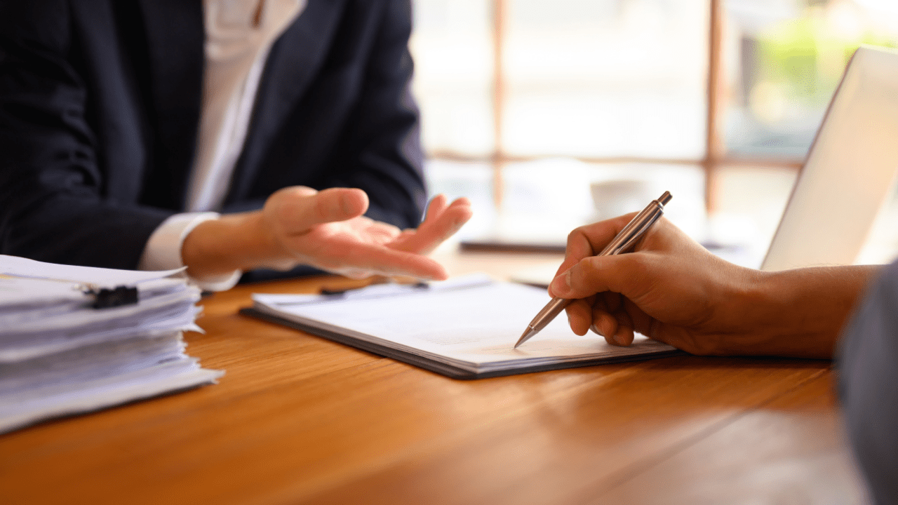 Professional attorney consultation for SSDI reconsideration with client reviewing and signing important documents