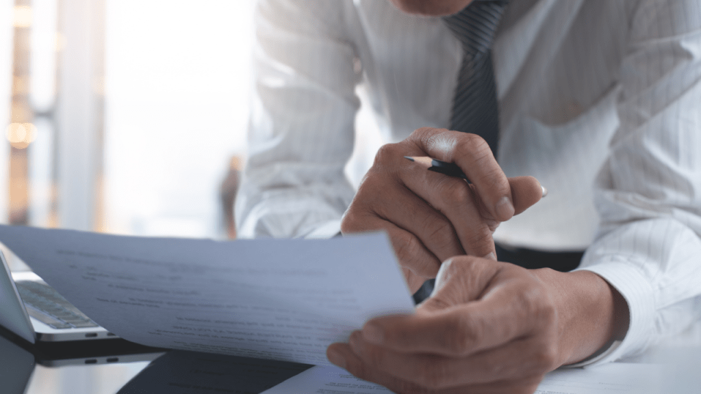 Professional reviewing SSDI reconsideration documents to improve odds of winning SSDI reconsideration appeal