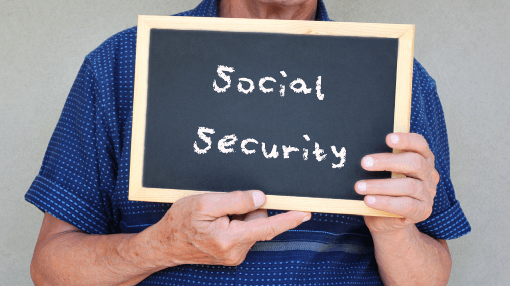Person holding chalkboard with Social Security text for SSDI reconsideration information