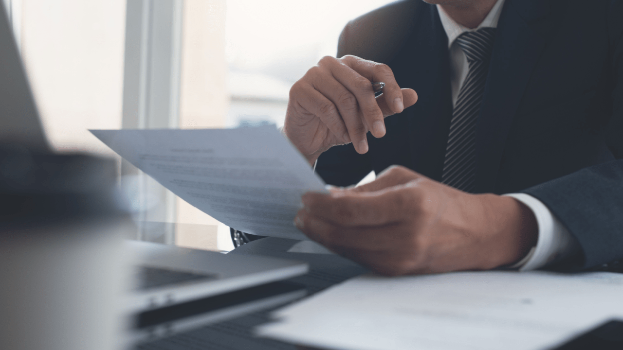 Professional business person stamping official documents showing how Social Security notify you of approval process