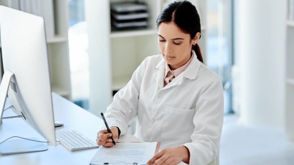 Medical professional writing documentation for SSDI letters of reconsideration work in modern office setting