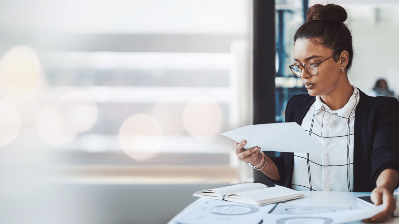 Professional woman reviewing SSDI documents while researching what are good reasons to request reconsideration for denied disability claims
