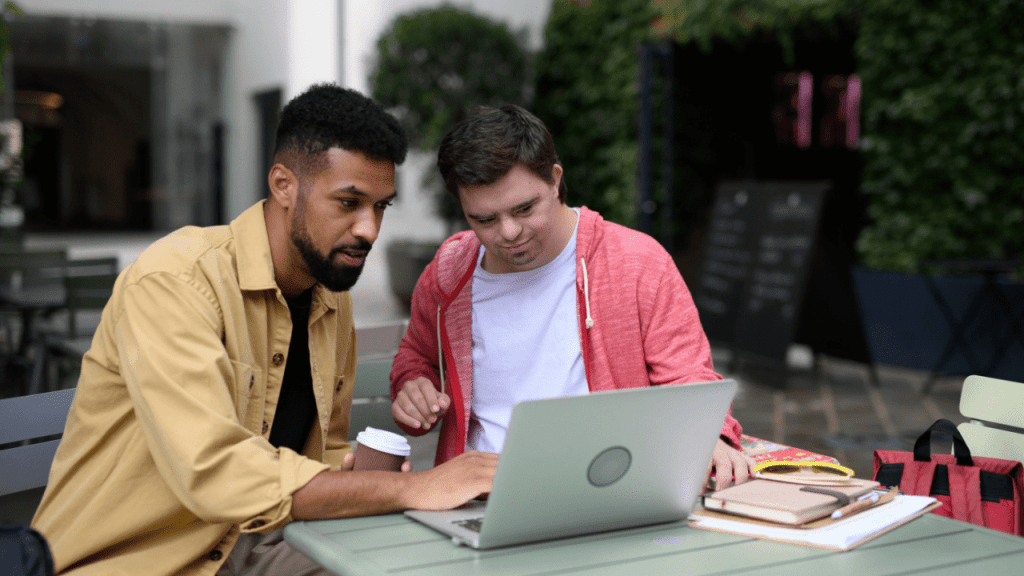 Support worker helping person with disability research does SSDI pay for the 5 month waiting period on laptop