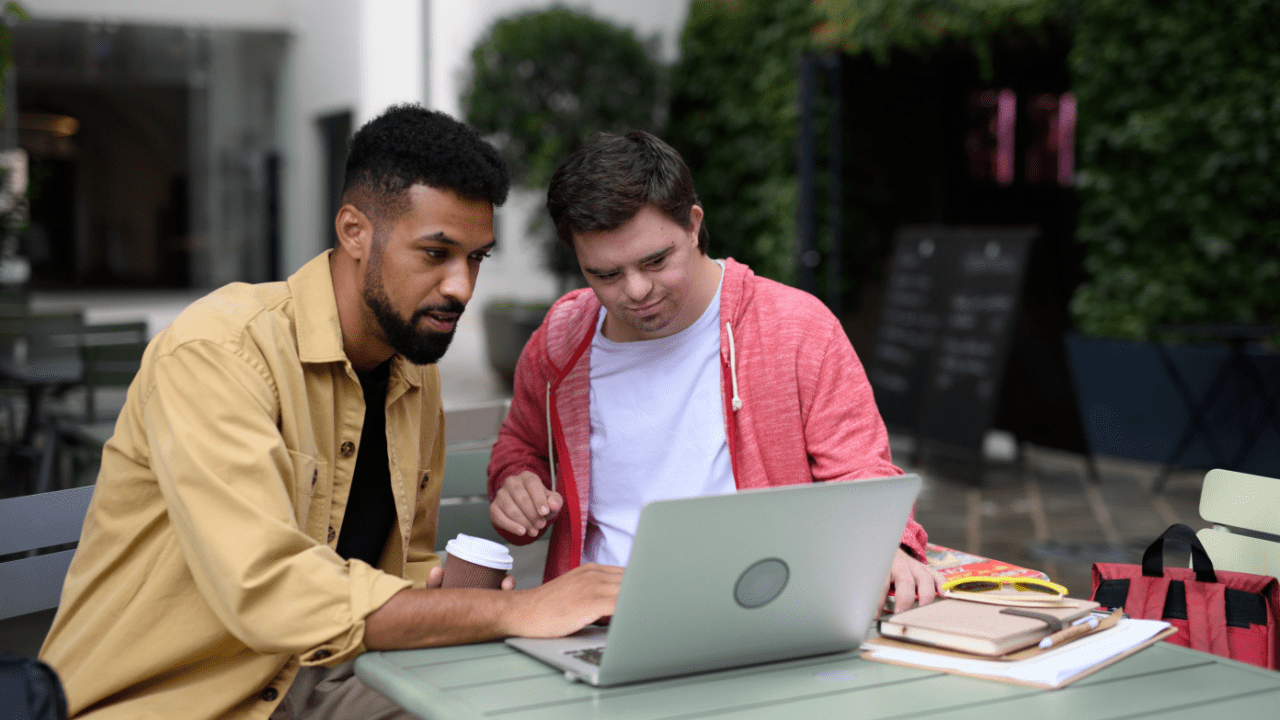 Support worker helping person with disability research does SSDI pay for the 5 month waiting period on laptop