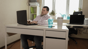Man working from home researching SSDI mistakes and disqualifications on laptop