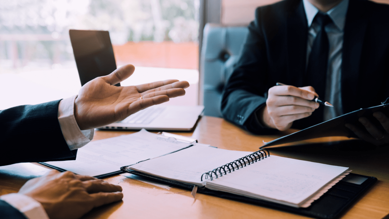 Professional consultation discussing the steps of the SSDI process with attorney and claimant reviewing documents