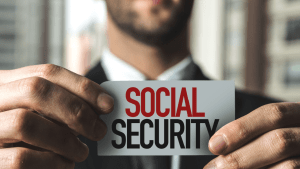 Professional holding Social Security card illustrating what qualifies you for SSDI benefits