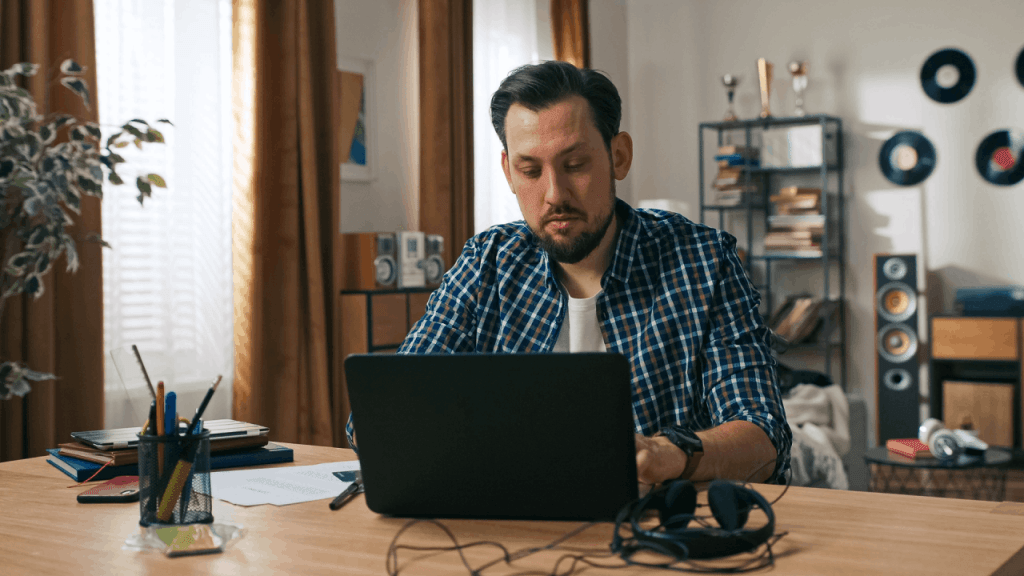 Man researching does SSDI pay you for the 5 month waiting period on laptop at home desk