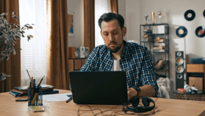 Man researching does SSDI pay you for the 5 month waiting period on laptop at home desk