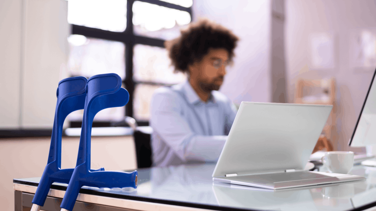 Person with crutches working on laptop illustrating how quickly SSDI decisions are made