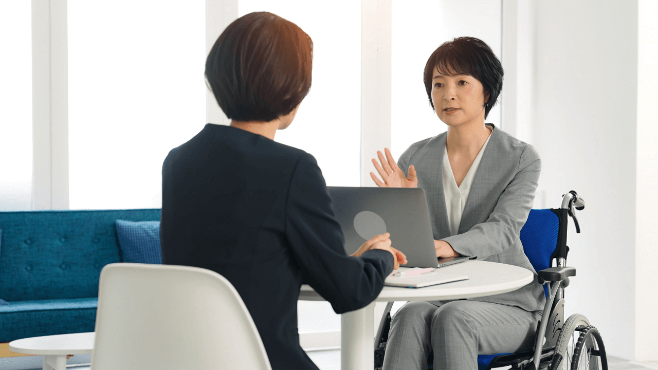 Professional discussing how SSDI updates affect current beneficiaries 2026 with disability recipient